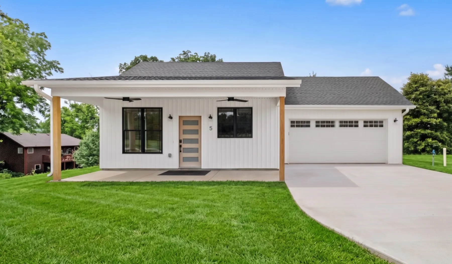Custom modern farmhouse with attached garage built by Evergreen Builders in Northwest Arkansas